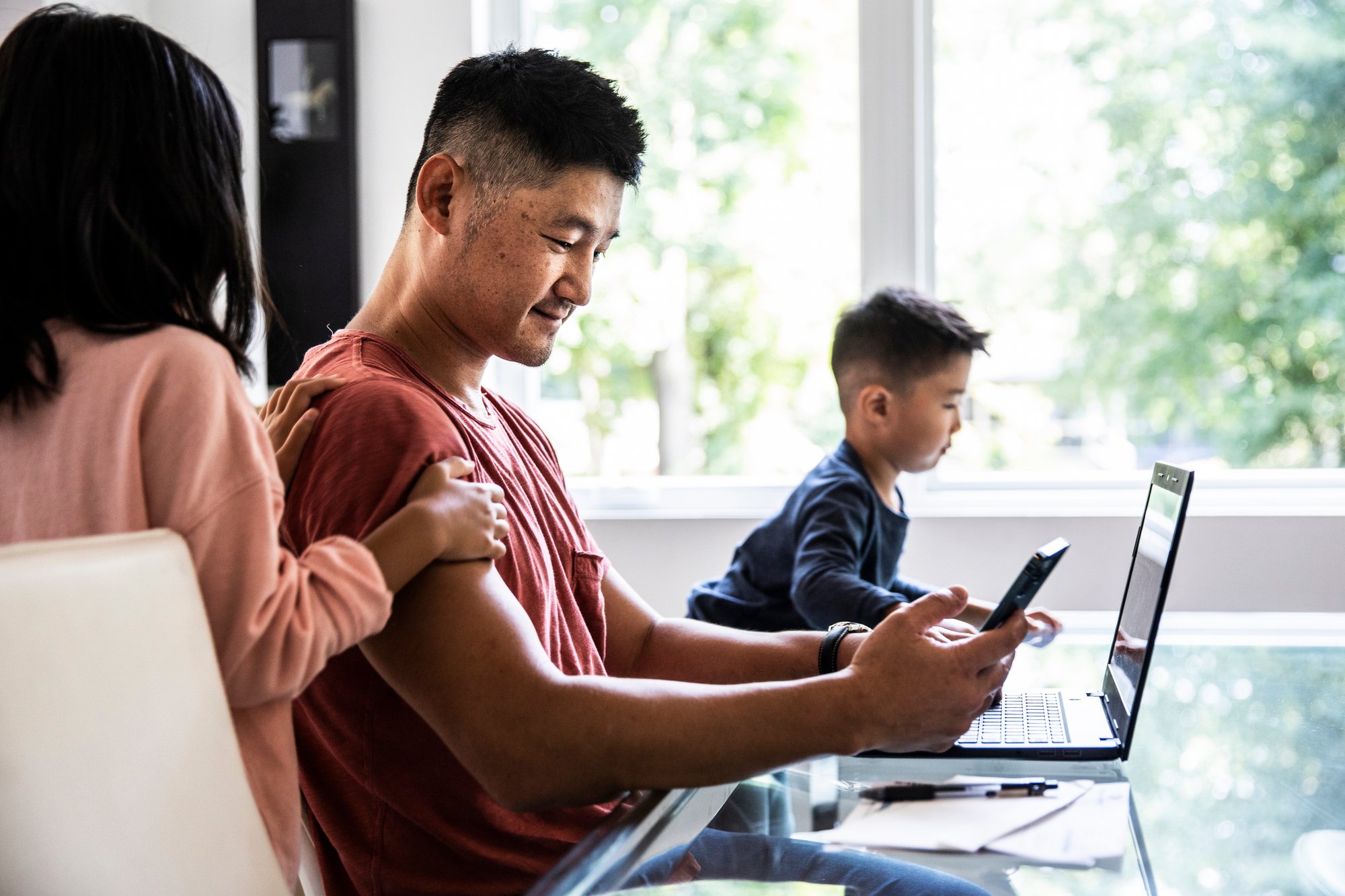 Dad working from home with two kids close by Dad working from home with two kids close by